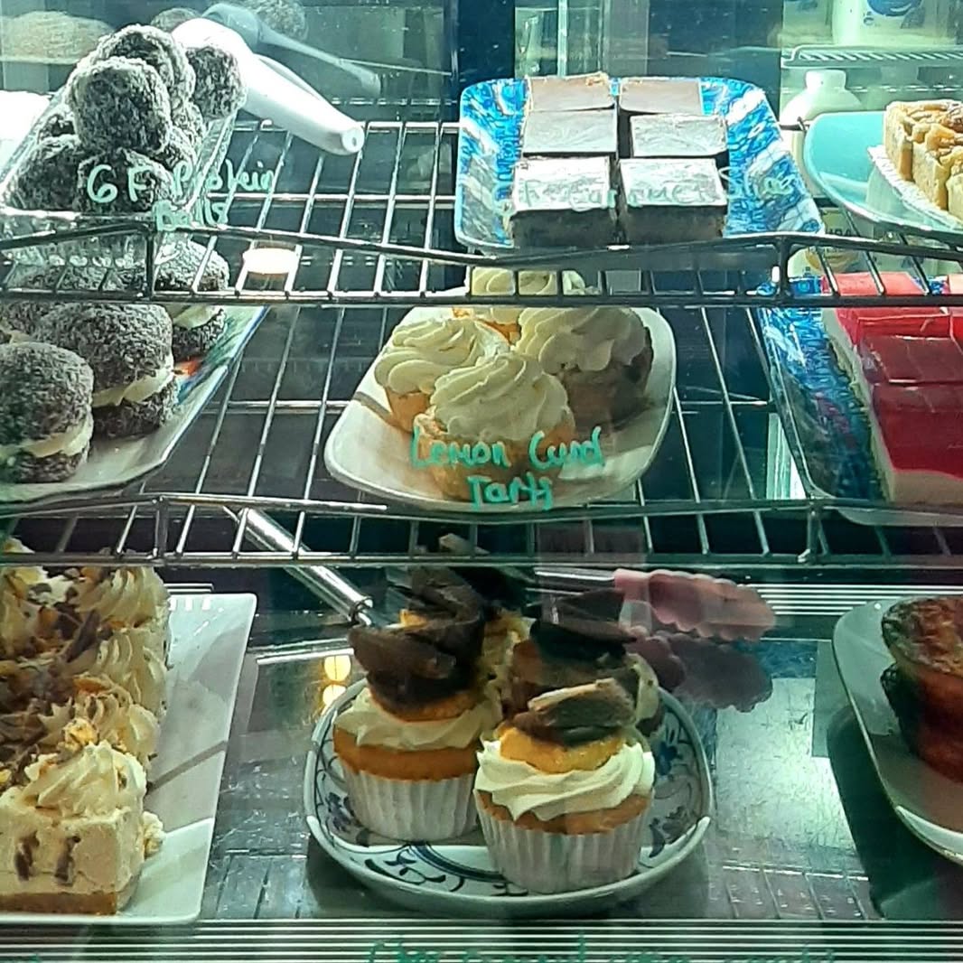 Protein balls, lamingtons, lemon curd tarts and cupcakes in the cabinet