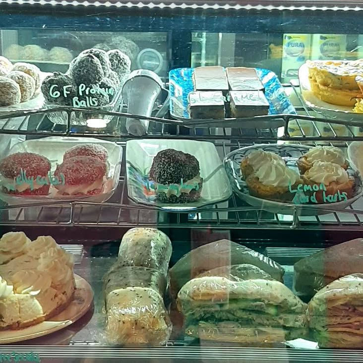 The full cabinet with protein balls, tarts, sandwiches and rolls