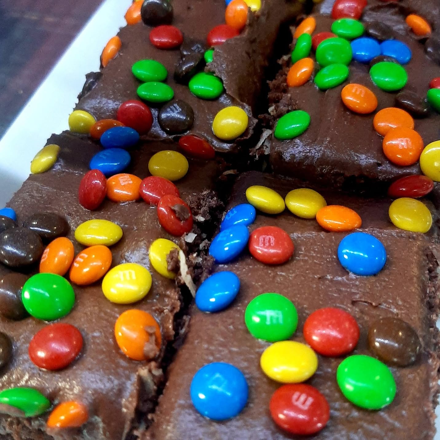 Chocolate slice topped with coloured chocolate buttons