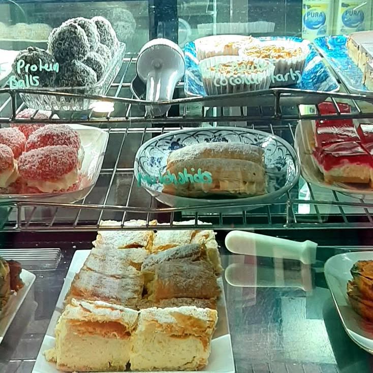 Coconut tarts, jelly slice and vanilla slice in the cabinet