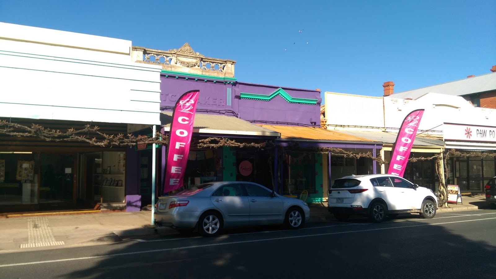 The purple shopfront on Victoria Street with pink coffee flags