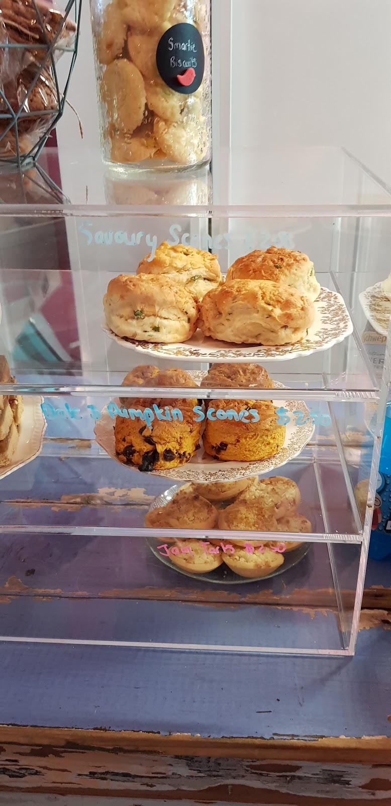 Savoury scones and pumpkin scones in an acrylic case with chalk labels